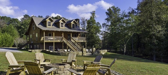 Large authentic 3-story log cabin adjacent to lake. Up to 14 guests.