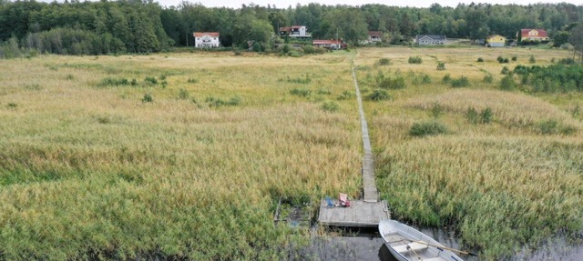 Seaside plot with private jetty, rowing boat & sunset